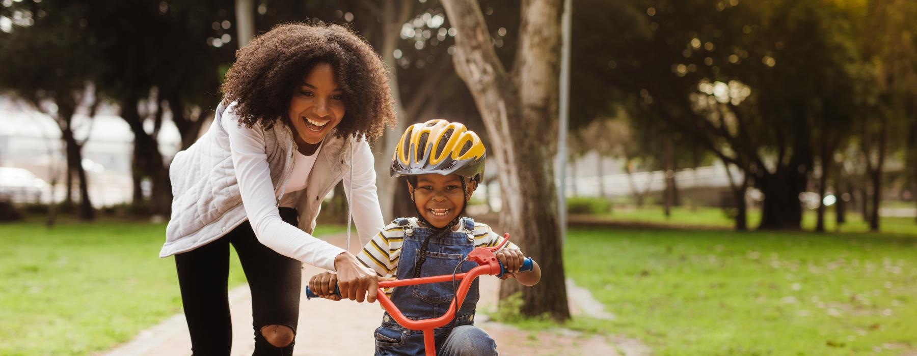 a person and a child riding a bicycle